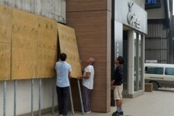 Locals board up their shops ahead of Tropical Cyclone Harold in Vanuatu's capital of Port Vila, April 6, 2020.