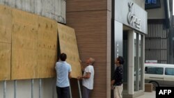 Locals board up their shops in Vanuatu's capital of Port Vila on April 6, 2020 ahead of Tropical Cyclone Harold.