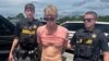 Ryan W. Routh, suspected of attempting to assassinate former President Donald Trump, stands handcuffed between two Martin County deputies after his arrest near Palm City, Fla., Sept. 15, 2024. (Martin County Sheriff's Office/Handout via Reuters)