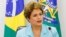 FILE - A handout picture released by the Brazilian presidency's press office shows President Dilma Rousseff during a meeting with representatives of Trade Unions at the Planalto Palace in Brasilia, April 30, 2015. 