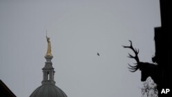 The statue of Lady Justice stands on top of the Old Bailey court in morning mist in London, March 3, 2021. 