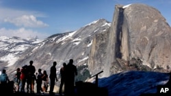 In this 2005 file photo, visitors view Half Dome from Glacier Point at Yosemite National Park, Calif. 