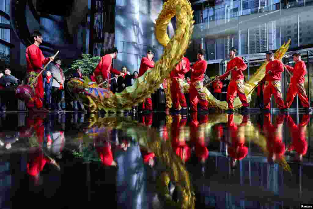 Dragon dancers perform in the lobby of the Shanghai Tower in the Pudong financial district after Lunar New Year holiday in Shanghai, China.