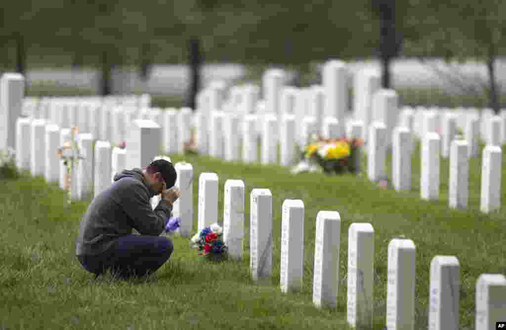 Former Marine Adam Furr visits the grave of his friend Marine Lt. Col. Kevin Michael Shea at Arlington National Cemetery in Arlington, Virginia, Monday, May 2, 2011. "It doesn't seem like it's in vain anymore" said Furr, who decided to visit after the dea