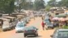 Cars and people move through Ekok, a Cameroonian village on the southwestern border with Nigeria.