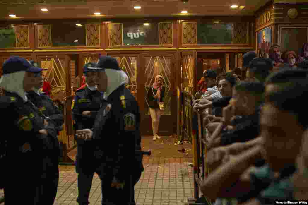 Single girls who came to the movie theaters are kept behind fences and guarded with policewomen to protect them from possible sexual harassment in downtown Cairo, June 15, 2018.