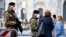 Italian soldiers wearing sanitary masks patrol Duomo square in downtown Milan, Italy, Feb. 24, 2020. 