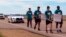 A group of teenagers and adults from Mississippi walk along U.S. Highway 61 on their 50-mile march to Memphis, Tennessee, as a tribute to slain civil rights leader Martin Luther King Jr., March 31, 2018, in Dundee, Miss. The group plans to attend events commemorating the 50th anniversary of King's death in Memphis on Wednesday.