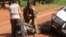 FILE - In this Sept. 16, 2013 photo, A Gabonese soldier from a regional Central African peacekeeping force helps collect the bodies of rebels who were reportedly killed by armed villagers in Njoh, Central African Republic.