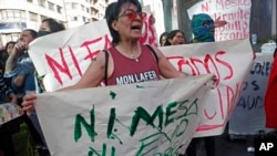 A woman holds the Spanish message: "Neither Mesa nor Evo in October" to protest the reelection of President Evo Morales, and also protest rival candidate, former President Carlos Mesa, in La Paz, Bolivia, Oct. 30, 2019.