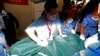 Hospital staff members carry the body of a Caucasian female to a hospital morgue in Seremban, Negeri Sembilan, Malaysia, Tuesday, Aug. 13, 2019. 