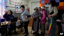 Voters register at a polling station in Ulaanbaatar, Mongolia, on June 28, 2024. Voters in Mongolia are electing a new parliament on Friday in their landlocked democracy that is squeezed between China and Russia, two much larger authoritarian states