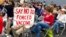 FILE - Audience members gather during a meeting of New Hampshire's Executive Council in Concord, N.H., Oct. 13, 2021. New Hampshire on Oct. 29 joined a lawsuit against the Biden administration seeking to block a COVID-19 vaccine mandate for federal contractors.