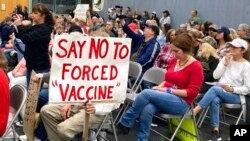 FILE - Audience members gather during a meeting of New Hampshire's Executive Council in Concord, N.H., Oct. 13, 2021. New Hampshire on Oct. 29 joined a lawsuit against the Biden administration seeking to block a COVID-19 vaccine mandate for federal contra