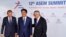 Japan's Prime Minister Shinzo Abe, center, is greeted by European Council President Donald Tusk, left, and European Commission President Jean-Claude Juncker during arrivals for the ASEM 12 in Brussels, Belgium, Oct. 18, 2018.