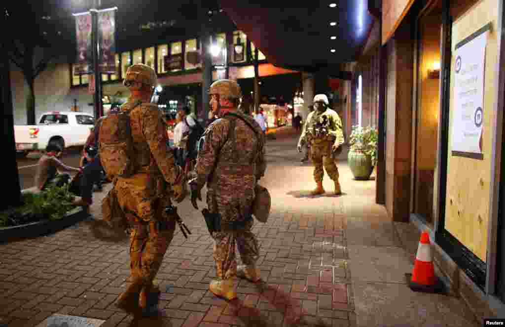 U.S. National Guard soldiers prepare for another night of protests over the police shooting of Keith Scott in Charlotte, North Carolina, Sept. 22, 2016.