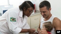 FILE - A nurse vaccinates a toddler against yellow fever at a public health clinic in Rio de Janeiro, Brazil, March 16, 2017. 