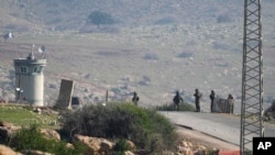 Israeli soldiers stand guard at a checkpoint where the military said an attacker fired at an army base near the village of Tayasir in the northern West Bank, Feb. 4, 2025. 