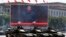 FILE - Chinese President Xi Jinping is displayed on a screen as Type 99A2 Chinese battle tanks take part in a parade commemorating the 70th anniversary of Japan's surrender during World War II, Tiananmen Gate, Beijing, China. 