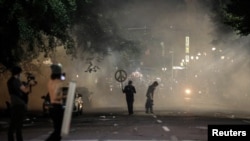 Demonstrators return to protest against racial inequality in front of federal buildings despite lingering tear gas fired by federal law enforcement officials in Portland, Oregon, July 19, 2020.