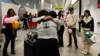 María Hastings, quien vive en Florida, EEUU, abraza por primera vez a su madre biológica a su llegada al aeropuerto de Santiago, Chile, el domingo 18 de febrero de 2024. 
