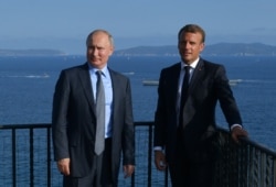 FILE - Russian President Vladimir Putin meets with French President Emmanuel Macron at Fort Bregancon near the village of Bormes-les-Mimosas, France, Aug. 19, 2019.