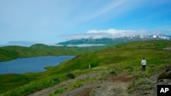 FILE - This July 8, 2021, photograph shows a hiker en route to Lake Bonnie Rose, one of many scenic hiking options on Adak Island, Alaska, where on Nov. 5, 2024, one of its residents will be the last American to cast an in-person ballot for president.