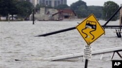 A ramp leading to the Memphis Queen riverboat and its parking area are surrounded by floodwater in Memphis, Tennessee, May 7, 2011.