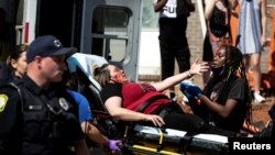 An injured protester is attended to during a rally against the death in Minneapolis police custody of George Floyd, in Columbia, S.C., May 30, 2020. 
