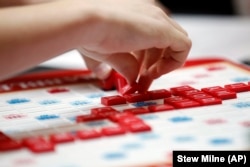 FILE - Claire Miklaucic, from Charlotte, N.C., plays a word during the first round of the 2015 North American School SCRABBLE Championship, at Hasbro headquarters in Pawtucket, R.I., Saturday, May 16, 2015. (Stew Milne/AP Images for Hasbro)