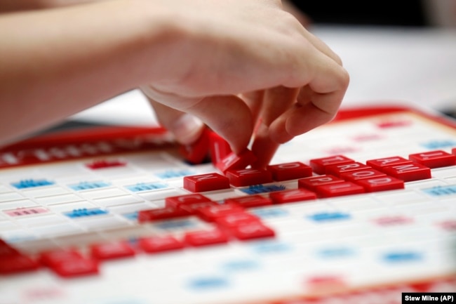 FILE - Claire Miklaucic, from Charlotte, N.C., plays a word during the first round of the 2015 North American School SCRABBLE Championship, at Hasbro headquarters in Pawtucket, R.I., Saturday, May 16, 2015. (Stew Milne/AP Images for Hasbro)