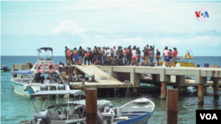 Los martes y los jueves son los días designados para transportar a migrantes entre los diferentes puertos. Las imágenes contrastan con los botes de turistas que llegan los fines de semana a disfrutar de un día de sol en las playas Capurganá.