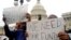 FILE - Protesters hold placards urging the U.S. Congress to end the federal government shutdown, on Capitol Hill in Washington, D.C., Oct. 9, 2013. 