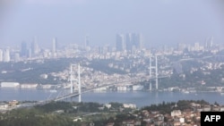 FILE - A general view of the July 15 Martyrs Bridge, or Bosphorus Bridge, as seen from a hill, in Istanbul, June 23, 2019. 