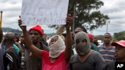 South Africans wave anti-immigration placards during a protest in Pretoria, South Africa, Feb. 24, 2017. Resentment against foreigners has sometimes turned deadly in South Africa amid accusations that they take jobs from locals.