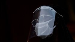 BRAZIL -- A woman wearing a face mask and shield to protect from the spread of the new coronavirus, takes part in a protest against racism and police violence during a "Black Lives Matter" demonstration in Duque de Caxias, Brazil, Wednesday, June 10, 2020