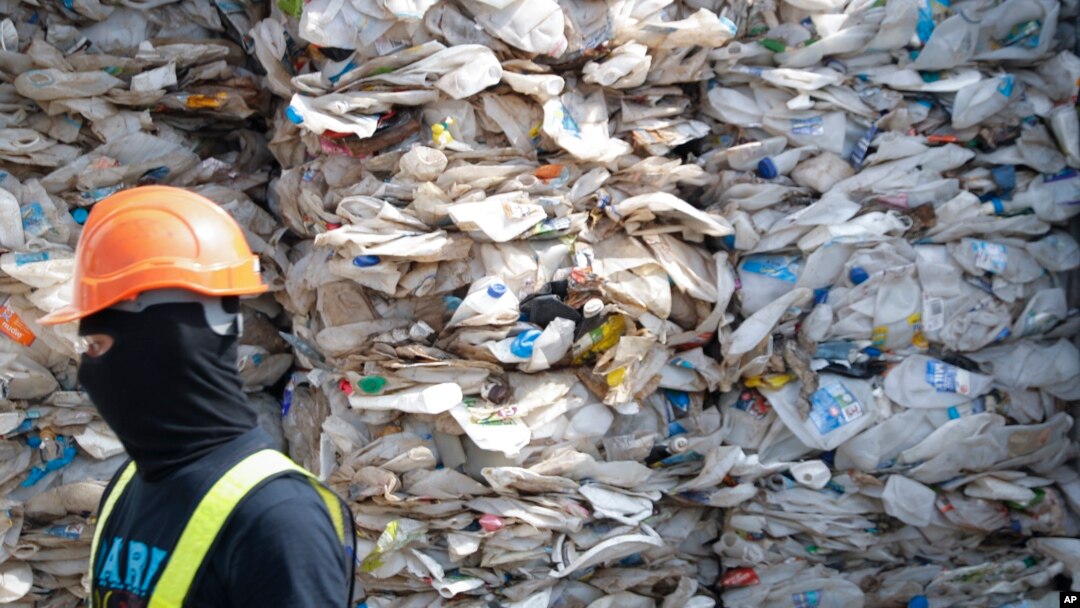 FILE - A container is filled with plastic waste from Australia, in Port Klang, Malaysia, May 28, 2019.