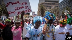 FILE - Around a thousand protesters, some wearing outfits made from plastic bottles and bottle-tops to raise the issue of plastic pollution, march to demand action on climate change, in downtown Nairobi, Kenya.