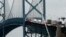 FILE - In this June 12, 2018, photo, trucks cross the Ambassador Bridge from Windsor, Ontario into Detroit. In nearly a quarter-century since NAFTA was approved, a complex chain of automotive parts makers has sprung up on both of the U.S.-Canada border. 