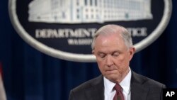 FILE - Attorney General Jeff Sessions pauses during a news conference at the Justice Department in Washington, March 2, 2017. 
