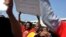 Striking members of the South African Transport and Allied Workers Union (SATAWU) hold placards outside Johannesburg's O.R. Tambo International Airport, Aug. 26, 2013.