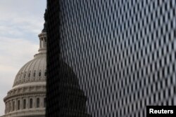 The U.S. Capitol dome is seen behind a security fence in Washington, Jan. 11, 2021.