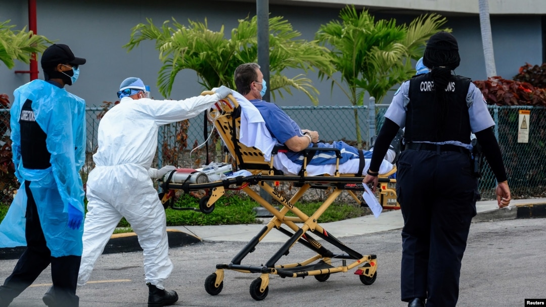 Emergency Medical Technicians (EMT) arrive with a correctional patient at North Shore Medical Center where the coronavirus disease (COVID-19) patients are treated, in Miami, Florida, July 14, 2020.