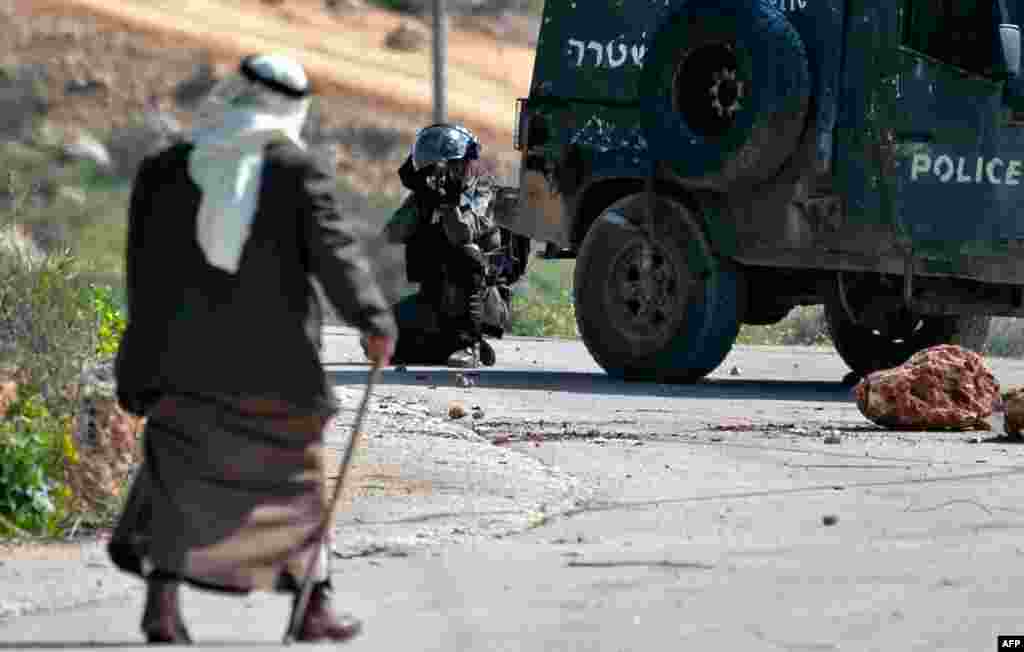 Israeli security forces keep position during clashes with Palestinian protesters in the village of Baita south of Nablus in the occupied West Bank. 