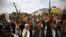 Shi'ite rebels known as Houthis hold up their weapons as they chant slogans during a rally against Saudi-led airstrikes in Sana'a, Yemen, Aug. 24, 2015.