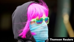 A person wears a scarf as a protective face mask in Melbourne, the first city in Australia to enforce mask-wearing to curb a resurgence of COVID-19