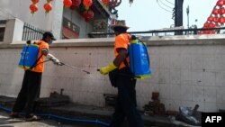 A city government worker disinfects a street as a preventive measure against the COVID-19 coronavirus in Yangon.