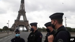 French police officers secure the bridge leading to the Eiffel Tower, Sept. 23, 2020 in Paris after a phone-in bomb threat.