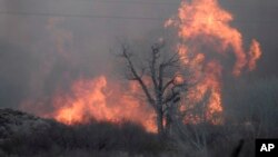 This Feb. 18, 2018 photo taken by the Bishop California Highway Patrol and released by the Inyo County Sheriff's Office shows smoke rising from wildfires near Bishop, California.