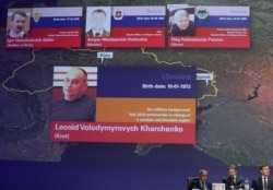 Russian nationals Igor Girkin, Sergey Dubinskiy, Oleg Pulatov, and Ukrainian Leonid Kharchenko, accused of downing of MH17, are shown on screen as international investigators present their latest findings, in Nieuwegein, Netherlands, June 19, 2019.